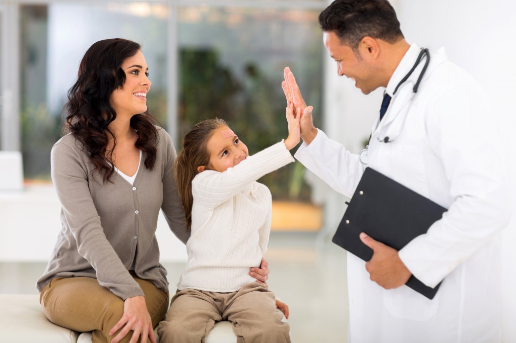 little girl and paediatrician doing high five